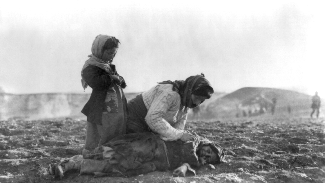 And Armenian woman kneeling over her child, 1915